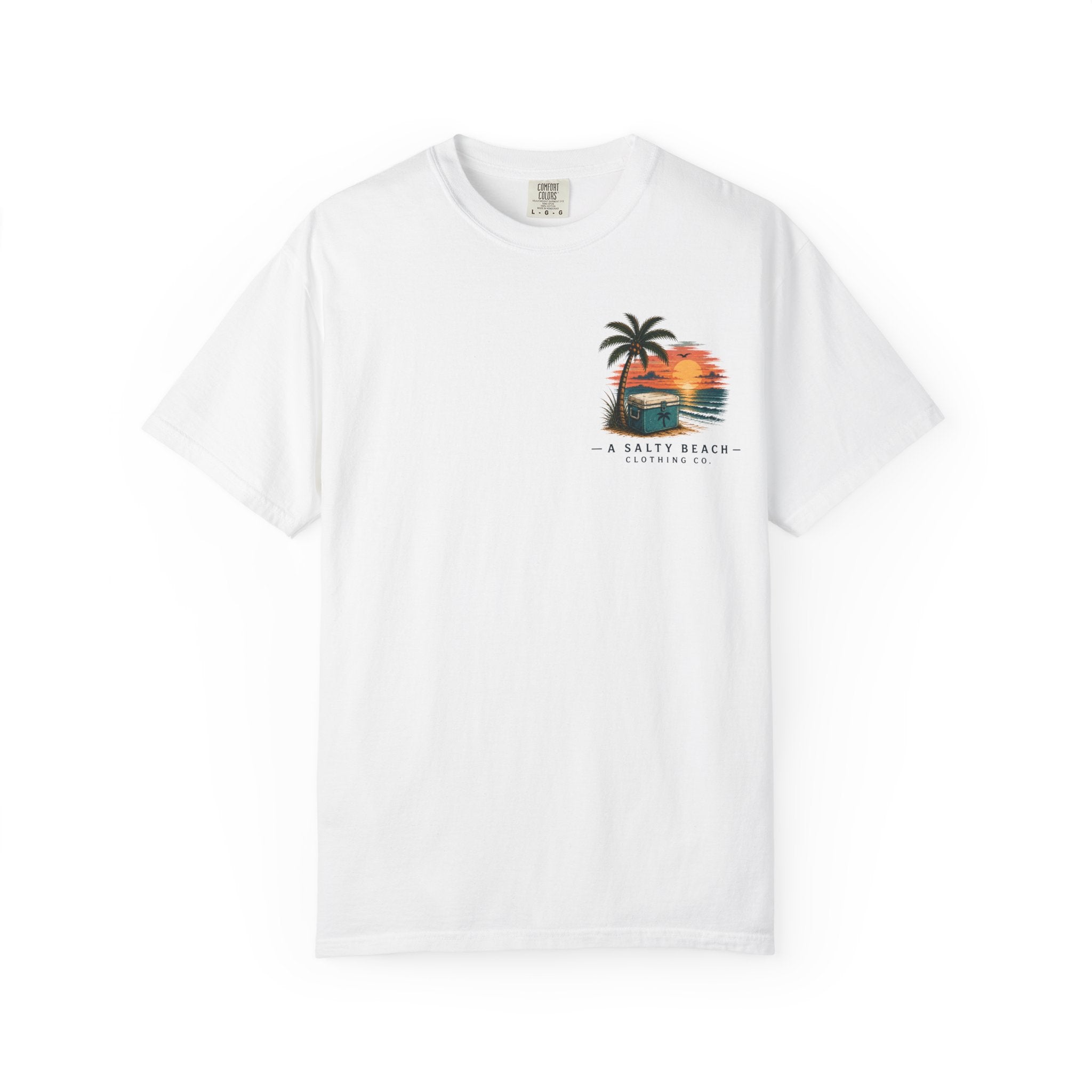 A white short-sleeve crewneck t-shirt featuring a colorful graphic on the left chest of a palm tree, a beach cabana, and a sunset, with the text 'A SALTY BEACH - CALIFORNIA' printed below.